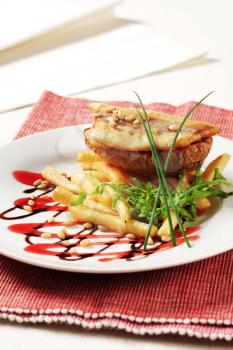 Pan fried fish fillet with baked potato and French fries