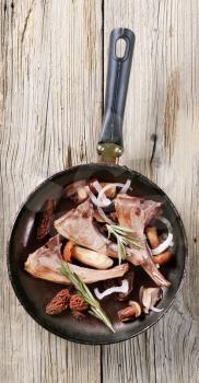 Roast lamb chops and mushrooms on a pan