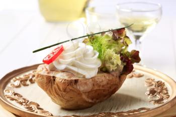 Baked potato topped with creamy spread