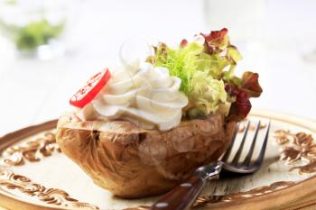 Baked potato topped with creamy spread