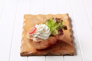 Baked potato with cream cheese and lettuce