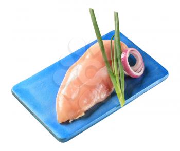 Raw chicken breast on a cutting board