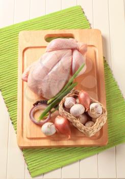Raw chicken, fresh onion and garlic - still life
