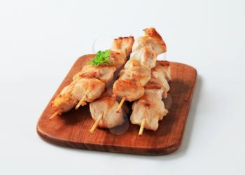 Chicken skewers on cutting board