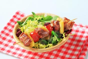 Grilled pork skewer and spring salad mix