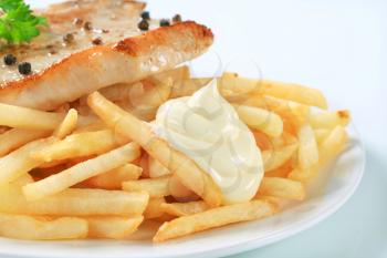 Pan seared pork chop with French fries and mayonnaise