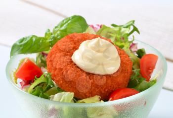 Fried cheese with fresh vegetable salad and mayonnaise