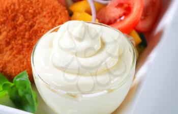 Closeup of a mayonnaise swirl in a glass cup