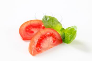 Fresh tomato wedges on white background