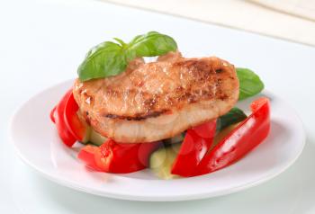 Pork cutlet with fresh red bell pepper and zucchini sticks