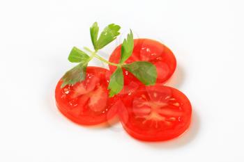 Slices of fresh tomato on white background