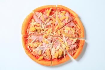 Pizza Hawaii cut into eighths