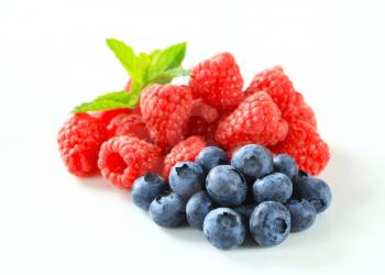 Studio shot of fresh raspberries and blueberries