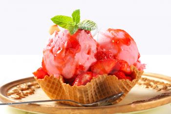 Ice cream with fresh strawberries in waffle basket