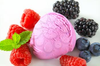Scoop of fruit ice cream with fresh mixed berries