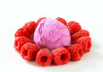 Scoop of fruit ice cream with fresh raspberries