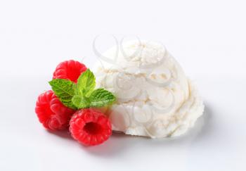 Scoop of creamy ice cream with fresh raspberries