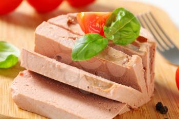 Smooth liver pate on cutting board