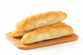 White bread rolls on cutting board