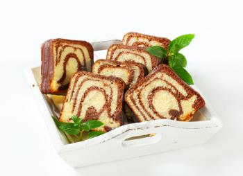 Slices of marble cake with chocolate icing