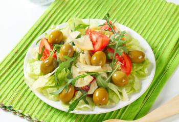 Fresh vegetable salad with green olives and Parmesan
