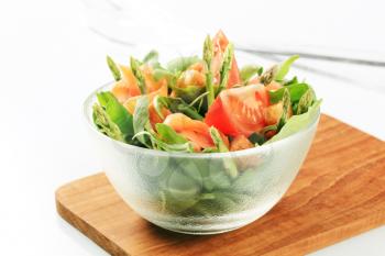 Bowl of greens with smoked salmon and asparagus 