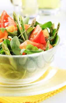 Bowl of greens with smoked salmon and asparagus 