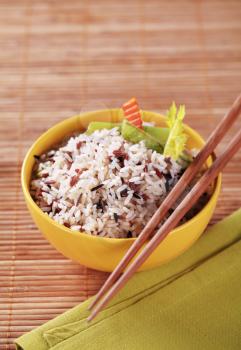 Bowl of mixed rice and wooden chopsticks