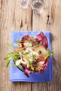 Salad greens with lentil sprouts, cheese and crispy bake rolls