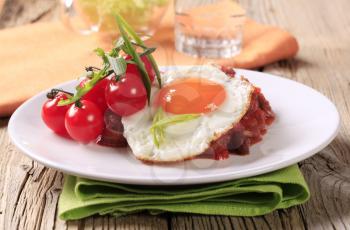 Vegetarian dish of red beans and tomato and fried egg