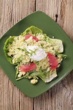 Couscous with red orange and rocket, poached egg on top