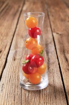 Red and yellow cherry tomatoes in a carafe