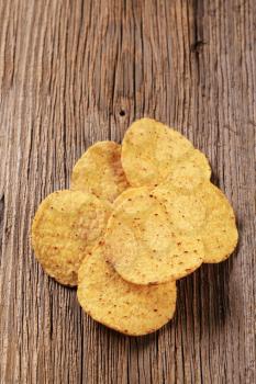 Crunchy tortilla chips on wood - closeup