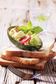 Avocado salad and slices of toasted bread 