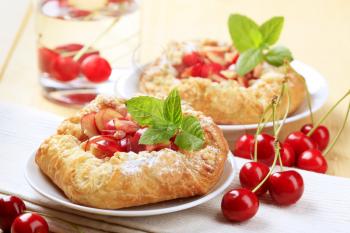 Danish pastry topped with fresh cherries - detail
