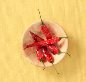 Red chili peppers in a wooden bowl
