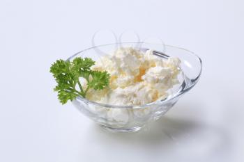 Bowl of curd cheese garnished with parsley