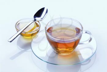 Cup of tea and honey - studio shot