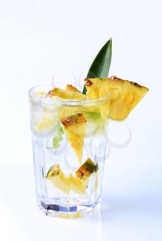 Glass of iced drink with fresh pineapple