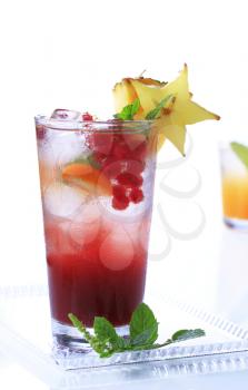 Glass of iced drinks garnished with fruit