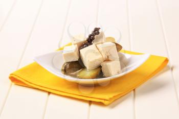 Cubes of marinated feta cheese and pickles
