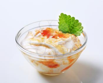 Bowl of Creme fraiche or yogurt with apricot jam