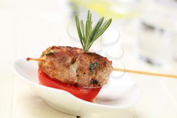 Minced meat kebab on a wooden stick