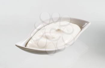 Studio shot of a bowl of white yogurt