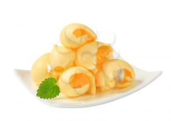 Curls of fresh butter on plate
