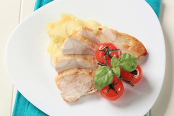 Slices of roasted chicken breast and mashed potato
