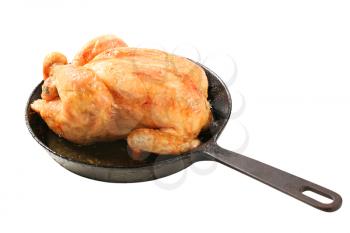 Roasted chicken on an iron skillet 