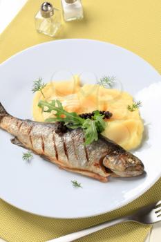 Dish of grilled whole trout and mashed potato
