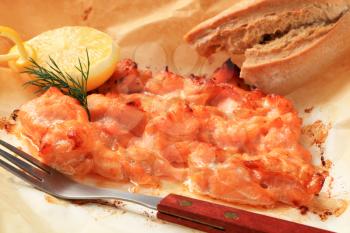 Salmon in parchment with lemon and bread roll