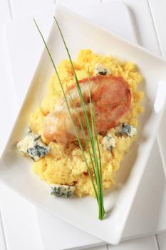 Seared chicken breast served with couscous and blue cheese